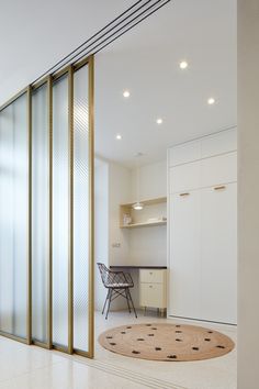 an empty room with sliding glass doors and a rug on the floor