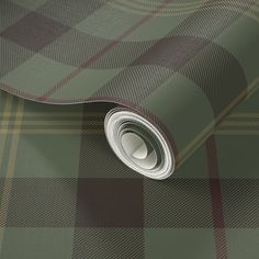 a green and brown checkered wallpaper with a rolled up roll on it's side