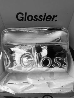 a close up of a bag in a box with the word glosse on it