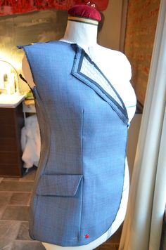 a mannequin with a blue vest on display