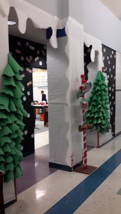 christmas trees are on display in the hallway