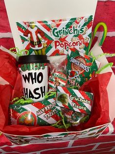 a christmas gift basket with coffee, candy and candies in red paper wrappers