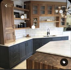 a kitchen with wooden cabinets and marble counter tops