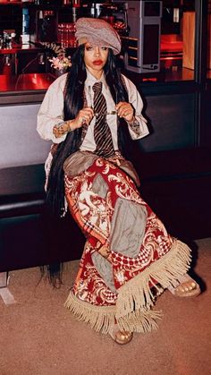 a woman dressed up as a pirate sitting on the floor in front of a bar