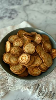 a bowl filled with sliced onion rings on top of a table