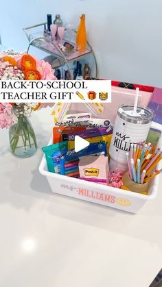 back - to - school teacher gift basket with flowers, pens and pencils in it