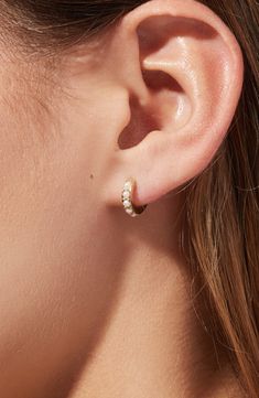 Featuring lustrous Swarovski pearls in a pavé setting, these elegant pearl huggie hoops are this season’s must-have. Carefully crafted in 100% recycled Sterling Silver and dipped in 14k gold, these pearl huggie hoops will add a dainty vibe to any outfit. Recycled Sterling Silver huggies with a thick 14k gold coating Feature perfect Swarovski pearls in a pavé setting Comfortable to wear & hypoallergenic Width:11.6mm - 0.5" Depth: 1.9mm - 0.1" Weight: 1g Hoop Diameter: 11.6mm - 0.5" Post: Stainles Wedding Earrings Rose Gold, Double Piercing Wedding Earrings, Pearl Stud Earrings Simple, Every Day Earrings, Simple Drop Earrings, Gold Dainty Earrings, Dainty Earring Stack, One Ear Piercing, Simple Wedding Earrings