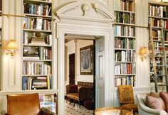 a room filled with lots of books and furniture