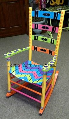 a brightly colored rocking chair in the middle of a room with other items on display