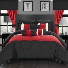 a bed with red and black comforters in a room