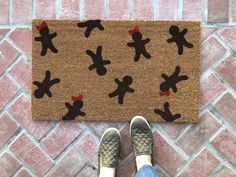 someone is standing in front of a door mat with teddy bears on it