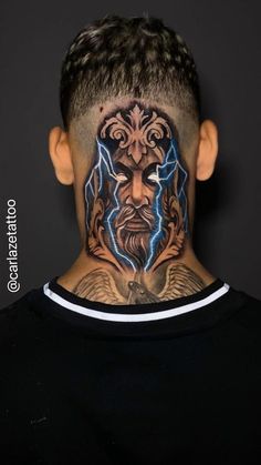 a man with tattoos on his face and neck