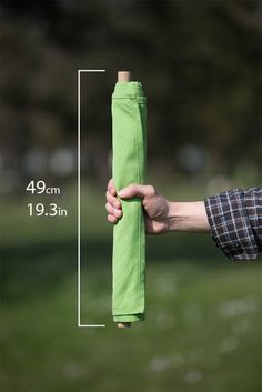 a person holding an umbrella in their hand with the measurements for each piece on it