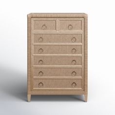 the chest of drawers is made out of wicker and has five drawers, one with four