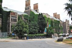 an old building with ivy growing on it's side and bicycles parked in front