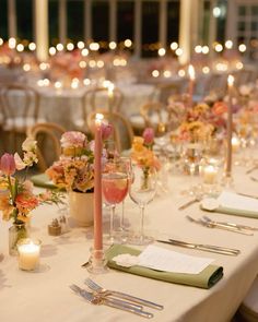 a long table is set with candles and place settings for an elegant dinner or party