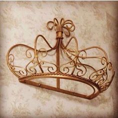 a gold metal crown hanging on the wall