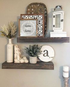 two wooden shelves with decorative items on them and a sign that says home is where the heart is