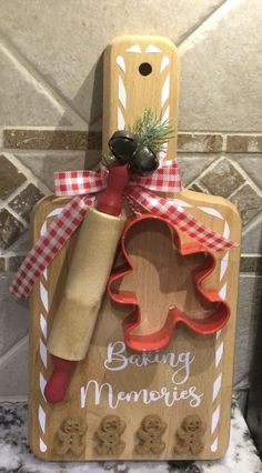 a wooden cutting board with cookie cutters and rolling dough on it that says baking memories