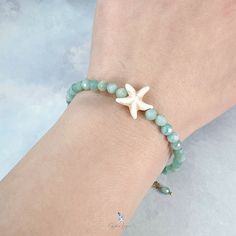 This cute starfish Amazonite stone bead bracelet features 4.2 mm faceted natural Mozambique Amazonite bead on stainless steel soft wire to maintain the round shape of the bracelet, a starfish bead added to the bracelet as an accent. The bracelet comes with a 5 cm adjustable stainless steel chain. Bracelet length: 18 cm + 5 cm adjustable chain Bead diameter: 4.2 mm Materials: Amazonite, stainless steel Jewelry Care: See more information about how to care for your jewelry here. Shipping Policy: Orders will be shipped within 1-3 business days. Economy shipping will take 7-14 days to arrive and standard shipping is 1- 4 days for U.S. orders. International shipping time is depended on the country and per shipping method. Shipping cost will be calculated at check out.For more details, see our Sh Adjustable Beaded Bracelet With Starfish Charm As Gift, Adjustable Starfish Beaded Bracelet, Adjustable Starfish Charm Bracelet Gift, Adjustable Starfish Beaded Bracelets, Adjustable Starfish-shaped Beaded Bracelet, Adjustable Star Crystal Bracelet For Gifts, Adjustable Star Crystal Bracelet As Gift, Adjustable Star Crystal Bracelet Gift, Adjustable Star-shaped Crystal Bracelet Gift