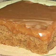 a close up of a piece of cake on a plate with frosting and chocolate