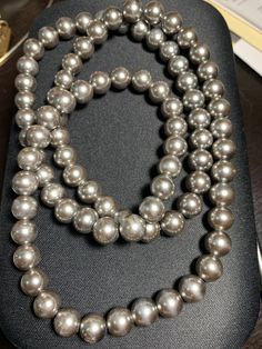 Beautiful vintage gray/silver simulated pearl necklace.   Necklace Length:  30 inches Classic Silver Pearl Necklace For Party, Elegant Gray Necklace For Evening, Gray Round Necklace For Formal Occasions, Luxury Gray Pearl Necklace As Gift, Gray Pearl Necklace For Formal Occasions, Elegant Long Gray Necklace, Grey Pearl Jewelry, Vintage Silver Long Pearl Necklace, Luxury Gray Pearl Necklace Gift