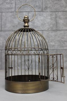 a metal birdcage sitting on top of a table