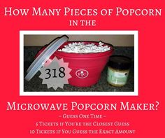 a red bucket filled with popcorn next to a jar