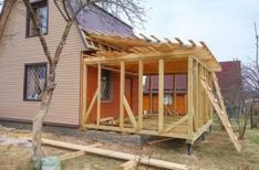 a house being built in front of a tree