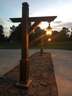 the sun shines brightly through an arch with two lamps on each side and stone walkway between them