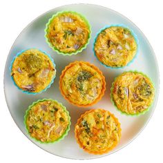 six small muffins on a plate with broccoli and other toppings