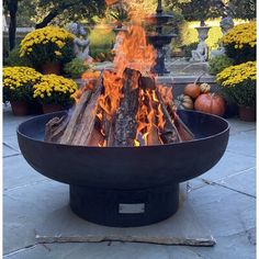 a large fire pit sitting on top of a stone floor