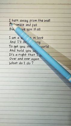 a blue pen sitting on top of a notepad next to a paper with writing