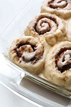 several cinnamon rolls in a glass baking dish