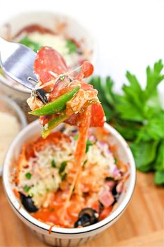 a spoon with some food in it on a table