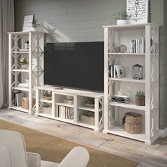 a white entertainment center with bookshelves and shelves