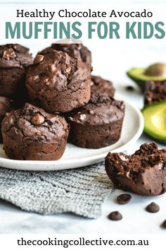 healthy chocolate avocado muffins for kids on a white plate with an avocado in the background