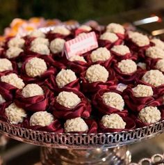 a large platter filled with lots of red and white desserts on top of a table