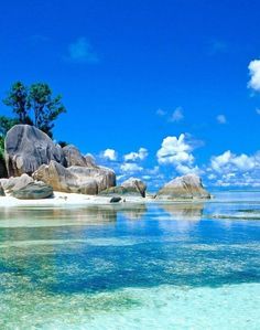 an island in the ocean with rocks and trees