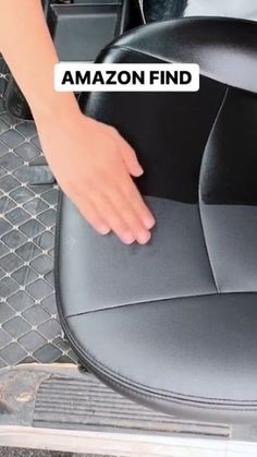 a hand is on the seat of a car with an amazon find sticker over it