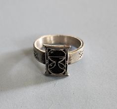 This ring was designed with the hour glass symbol. The beautiful pewter ring is a silver color and the background is blackened to bring out the fine detail of the design. Our rings are 100% Lead and nickel free pewter and made in the USA The top design part of the ring measures approx. 12.5mm x 9.5mm  The ring band tapers from about 5mm to about 4mm at the bottom and is about 1.5mm thick Picture shows size compared to a US Dime Rings are available in sizes 4 to 7 (half sizes also) Pewter Ring, Petite Ring, Hour Glass, Top Design, Ring Band, Rings Statement, Silver Color, Band Rings, Statement Rings