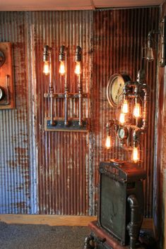 an old fashioned television sitting in front of a metal wall with lights on it's sides