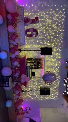 an overhead view of a room with balloons and lights on the ceiling, along with other decorations