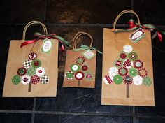 three brown bags with buttons and bows on them