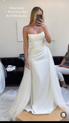 a woman taking a selfie in her wedding dress