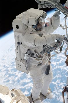 an astronaut in outer space with earth in the background