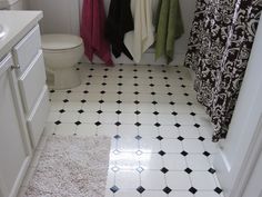 a bathroom with black and white tile flooring