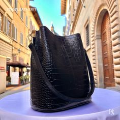 "This bag has been made of the best genuine leather by local master crafters of Florence in Italy, designed for women who only accept premium Italian quality and luxury leather bags and modern Italian fashion. . Size: Width: 27 cm / 10.75 inches Height: 19 cm / 7.50 inches Depth: 9 cm / 3.50 inches Color: Black . The story of this bag : Once upon a time, in the charming city of Florence, Italy, renowned for its exquisite artistry and craftsmanship, there existed a small workshop tucked away in a cobblestone alley. This was the home of a gifted artisan named Alessio, whose passion for creating beauty out of leather was unparalleled. Alessio specialized in handcrafted leather goods, and his most prized creations were the leather clutch bags that exuded elegance and sophistication. The timele Luxury Bucket-shaped Bags For Daily Use, Luxury Bucket Shoulder Bag For Travel, Luxury Bucket Shape Shoulder Bag For Travel, Luxury Daily Use Bucket-shaped Bag, Elegant Large Capacity Bucket-shape Shoulder Bag, Formal Textured Faux Leather Bag, Elegant Textured Faux Leather Bag, Rectangular Leather-lined Bucket Bag For Business, Business Shoulder Bag In Textured Faux Leather