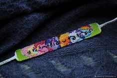 the beaded bracelet is decorated with cartoon characters