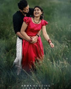 a man and woman standing in tall grass